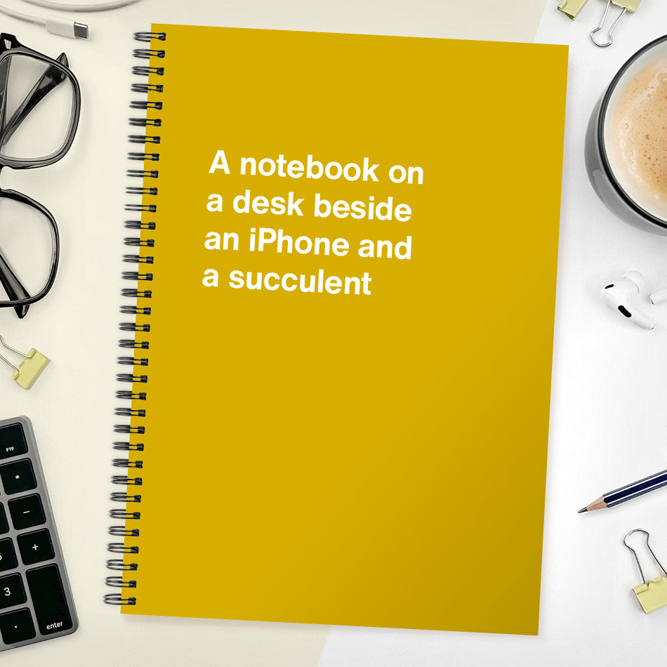 A notebook on a desk beside an iPhone and a succulent | WTF Notebooks